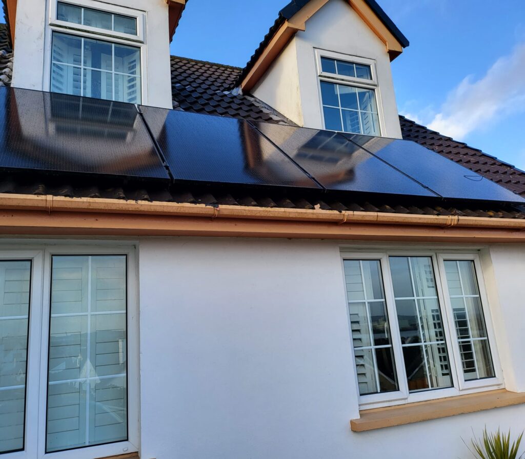 four solar panels installed below dormer windows