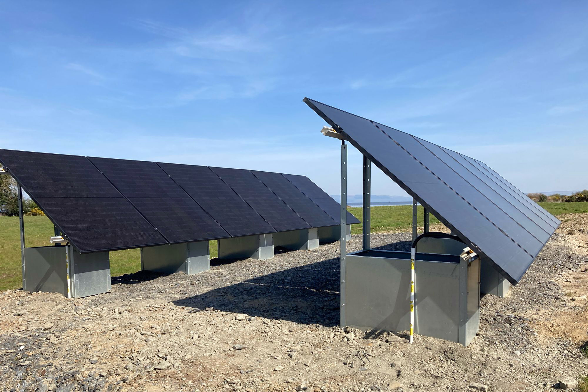 ground mounted solar panel system on a clear blue sky day