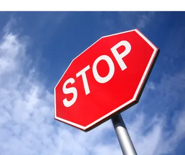 stop sign on cloudy sky