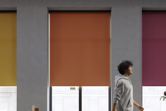 three roller blinds with man walking past and smiling